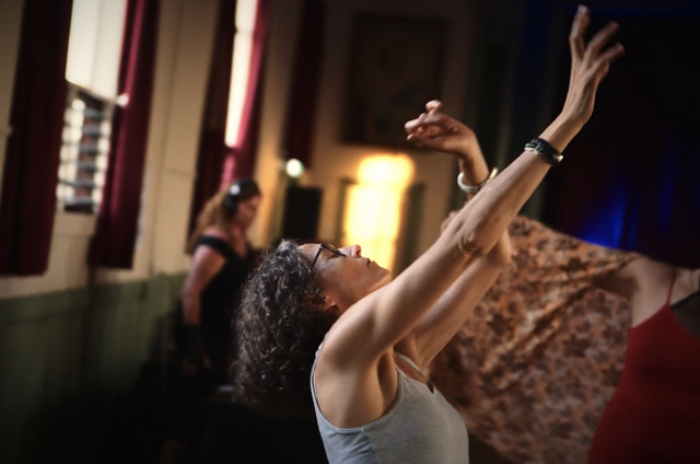 Hands reaching in dance movement